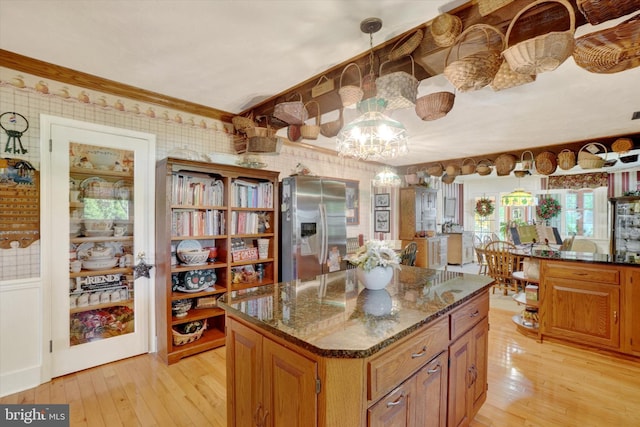 1150 S Mountain Rd, Dillsburg, PA 17019 - kitchen featuring stainless steel fridge with ice dispenser, light wood-style floors, a chandelier, brown cabinetry, and ornamental molding