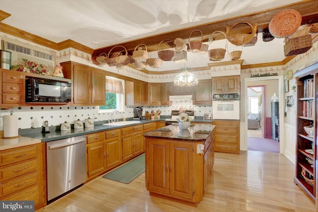 1150 S Mountain Rd, Dillsburg, PA 17019 - kitchen with white oven, black microwave, stainless steel dishwasher, a sink, and light wood-style flooring