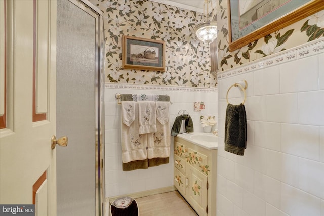 1150 S Mountain Rd, Dillsburg, PA 17019 - bathroom with wallpapered walls, vanity, tile walls, a stall shower, and a wainscoted wall