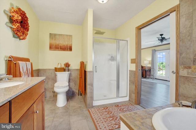 1150 S Mountain Rd, Dillsburg, PA 17019 - full bath featuring tile walls, vanity, a wainscoted wall, a stall shower, and toilet