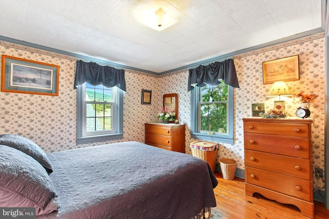 1150 S Mountain Rd, Dillsburg, PA 17019 - bedroom featuring wood-type flooring, crown molding, and wallpapered walls