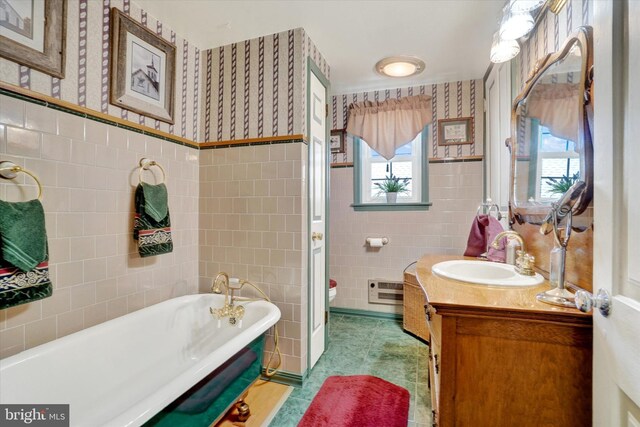 1150 S Mountain Rd, Dillsburg, PA 17019 - full bathroom with tile walls, wallpapered walls, a soaking tub, healthy amount of natural light, and vanity