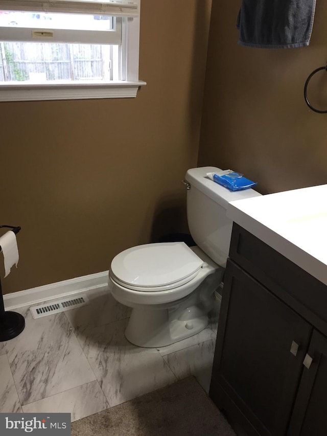 942 Monroe St, Harrisburg, PA 17113 - bathroom featuring vanity, toilet, baseboards, and marble finish flooring