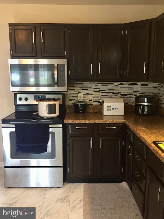 942 Monroe St, Harrisburg, PA 17113 - kitchen featuring appliances with stainless steel finishes, light marble finish flooring, and decorative backsplash