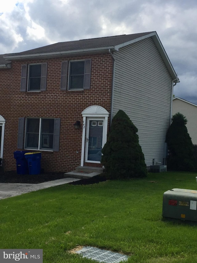 942 Monroe St, Harrisburg, PA 17113 - view of front of house featuring a front lawn, brick siding, and entry steps