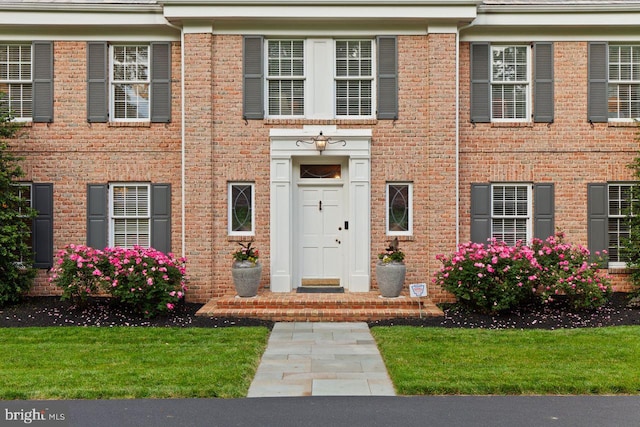 121 Eshelman Rd, Lancaster, PA 17601 - view of exterior entry featuring brick siding and a lawn