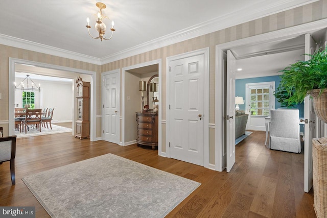 121 Eshelman Rd, Lancaster, PA 17601 - foyer with a chandelier, crown molding, wood finished floors, wallpapered walls, and baseboards