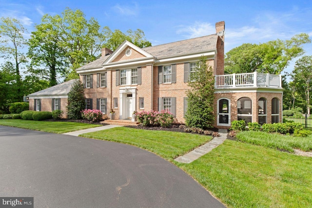 121 Eshelman Rd, Lancaster, PA 17601 - colonial-style house with a chimney, brick siding, and a balcony