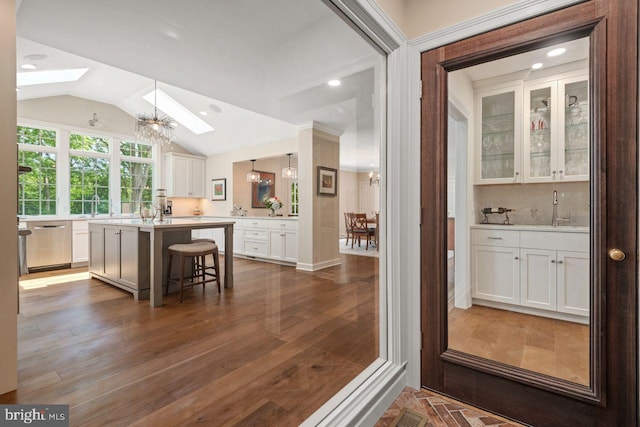 121 Eshelman Rd, Lancaster, PA 17601 - kitchen with a skylight, dishwasher, white cabinetry, light countertops, and a breakfast bar