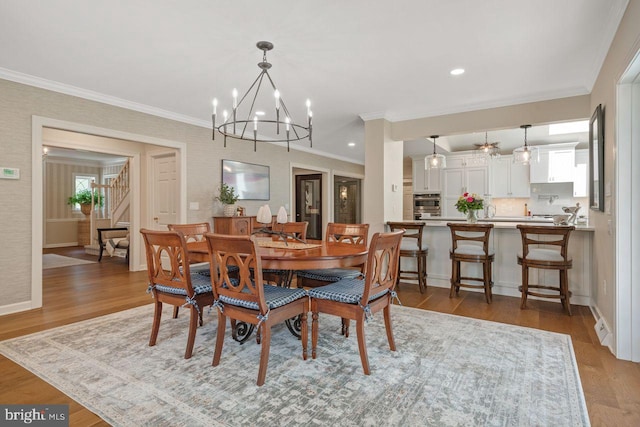 121 Eshelman Rd, Lancaster, PA 17601 - dining room with stairway, wood finished floors, crown molding, a chandelier, and baseboards