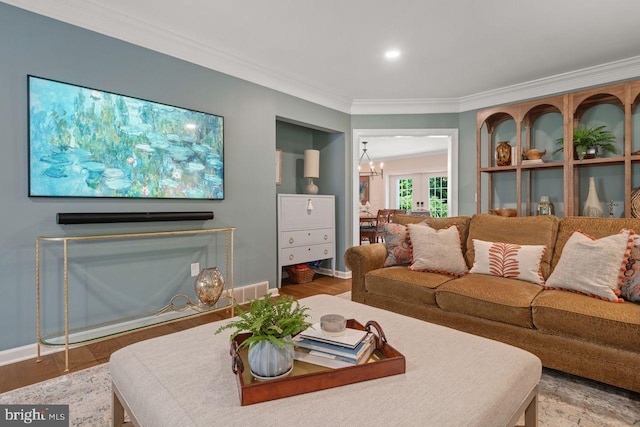 121 Eshelman Rd, Lancaster, PA 17601 - living area featuring ornamental molding, baseboards, wood finished floors, and a chandelier