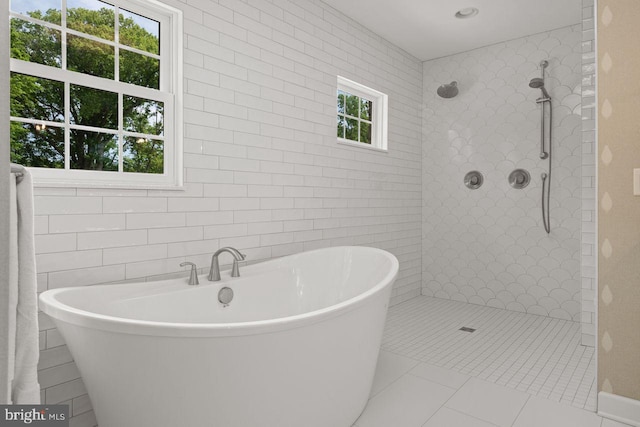 121 Eshelman Rd, Lancaster, PA 17601 - full bathroom featuring a soaking tub, a walk in shower, tile walls, and tile patterned flooring