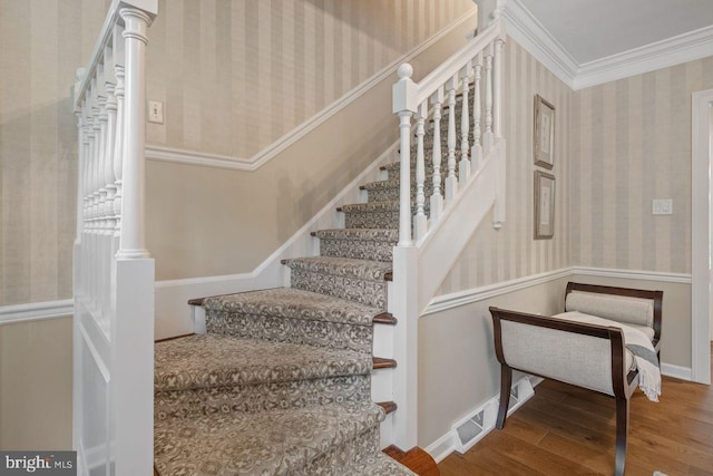 121 Eshelman Rd, Lancaster, PA 17601 - stairway featuring wallpapered walls, wood finished floors, baseboards, and ornamental molding
