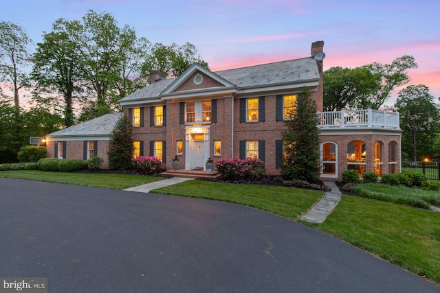 121 Eshelman Rd, Lancaster, PA 17601 - colonial-style house featuring a balcony, a chimney, brick siding, and a high end roof
