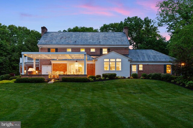 121 Eshelman Rd, Lancaster, PA 17601 - back of house at dusk featuring a high end roof, a chimney, and a pergola