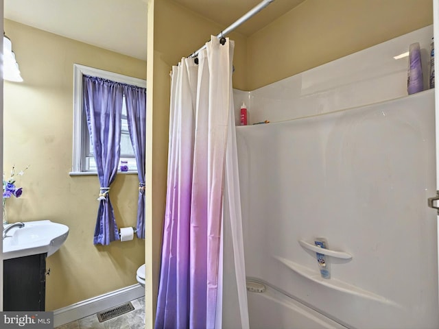 225 S State St, Ephrata, PA 17522 - full bath featuring vanity, shower / bath combo with shower curtain, toilet, and baseboards