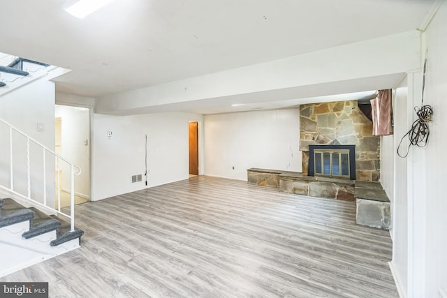 7910 Polk St, Lanham, MD 20706 - unfurnished living room featuring stairs, wood finished floors, and a fireplace