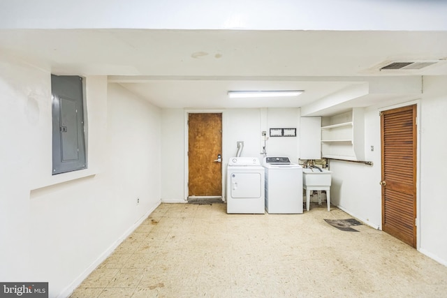 7910 Polk St, Lanham, MD 20706 - laundry room with washing machine and dryer, electric panel, tile patterned floors, a sink, and baseboards