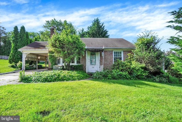 758 Rathton Rd, York, PA 17403 - view of front of home featuring concrete driveway, a carport, a front lawn, a chimney, and brick siding