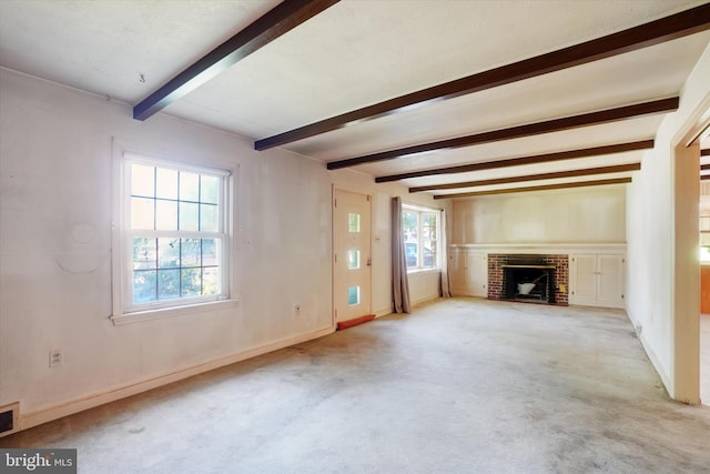 758 Rathton Rd, York, PA 17403 - unfurnished living room with beamed ceiling, a brick fireplace, light colored carpet, and baseboards