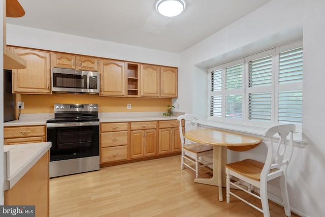 2339 Millennium Ln, Reston, VA 20191 - kitchen featuring stainless steel appliances, light countertops, light wood-type flooring, and light brown cabinetry