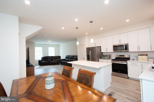 305 Shipyard Dr Unit 61, Cambridge, MD 21613 - kitchen with appliances with stainless steel finishes, light countertops, a kitchen island, recessed lighting, and white cabinetry