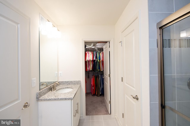 305 Shipyard Dr Unit 61, Cambridge, MD 21613 - bathroom with vanity, tile patterned floors, a walk in closet, and an enclosed shower