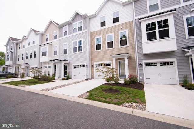 305 Shipyard Dr Unit 61, Cambridge, MD 21613 - view of property featuring concrete driveway, an attached garage, and a residential view