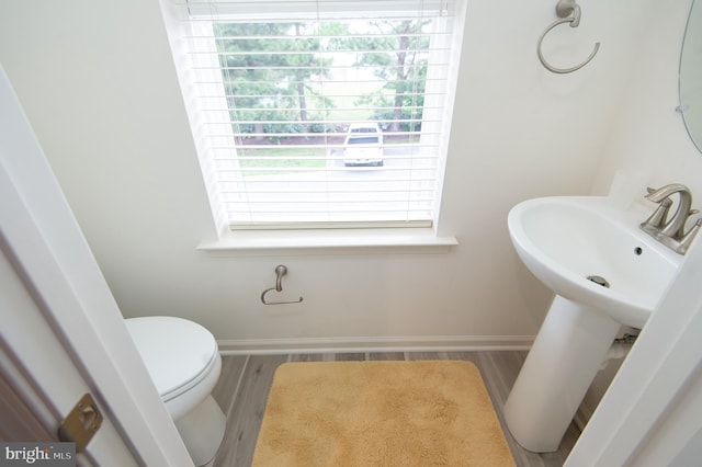 305 Shipyard Dr Unit 61, Cambridge, MD 21613 - bathroom with wood finished floors, baseboards, healthy amount of natural light, and toilet