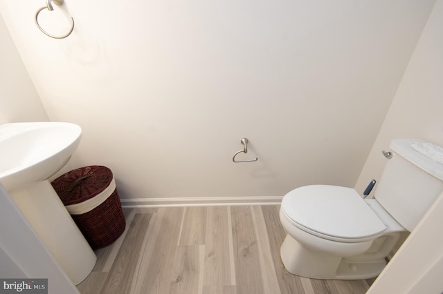 305 Shipyard Dr Unit 61, Cambridge, MD 21613 - bathroom with wood finished floors, toilet, and baseboards