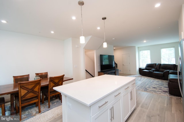 305 Shipyard Dr Unit 61, Cambridge, MD 21613 - kitchen featuring white cabinetry, light wood finished floors, open floor plan, a kitchen island, and recessed lighting