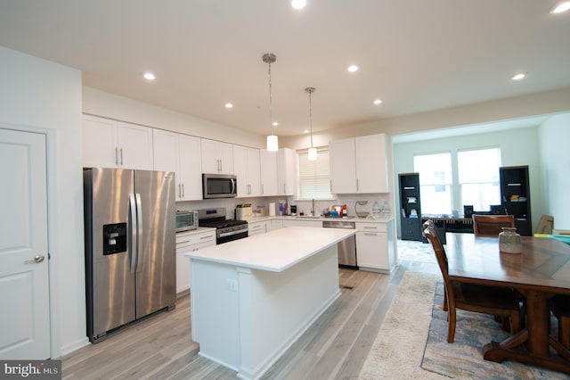 305 Shipyard Dr Unit 61, Cambridge, MD 21613 - kitchen with appliances with stainless steel finishes, a sink, a center island, white cabinetry, and light countertops