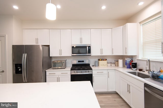 305 Shipyard Dr Unit 61, Cambridge, MD 21613 - kitchen with stainless steel appliances, a sink, white cabinets, light countertops, and recessed lighting