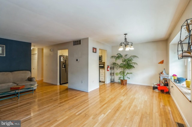 136 Chalkboard Ct, Moorestown, NJ 08057 - living room with light wood-type flooring, a chandelier, and baseboards