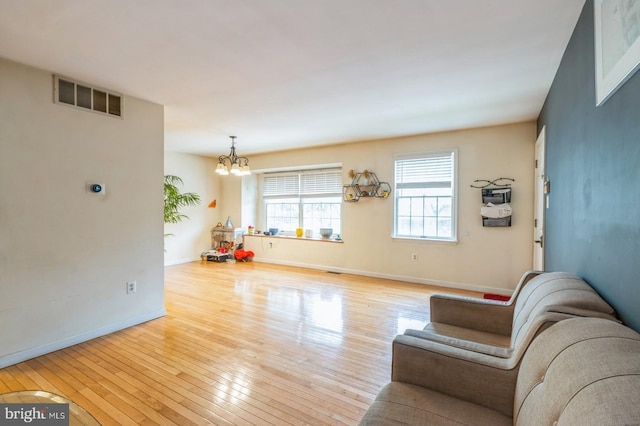 136 Chalkboard Ct, Moorestown, NJ 08057 - living room with a chandelier, hardwood / wood-style floors, and baseboards