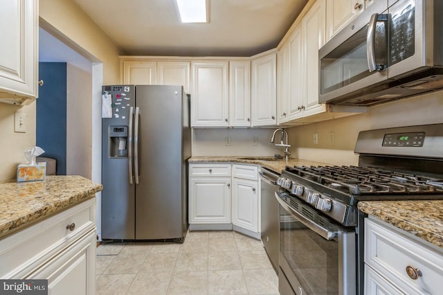 136 Chalkboard Ct, Moorestown, NJ 08057 - kitchen with stainless steel appliances, a sink, light stone countertops, white cabinets, and light tile patterned floors