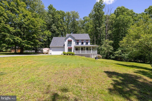 27 Athens Ln, Ruther Glen, VA 22546 - colonial-style house featuring covered porch, a front yard, a garage, and a wooded view