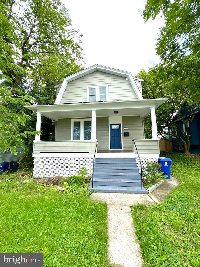 3303 Richmond Ave, Baltimore, MD 21213 - colonial inspired home featuring a gambrel roof, a porch, and a front lawn