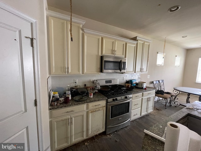 11337 Flag Ct, White Plains, MD 20695 - kitchen with appliances with stainless steel finishes, dark wood-style flooring, backsplash, cream cabinets, and pendant lighting