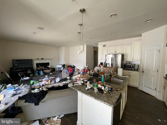 11337 Flag Ct, White Plains, MD 20695 - kitchen with stainless steel appliances, a sink, open floor plan, dark stone countertops, and dark wood-style floors