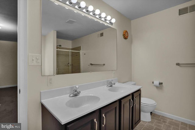 69 Calais Dr, Reading, PA 19605 - bathroom with double vanity, baseboards, tiled shower, and toilet