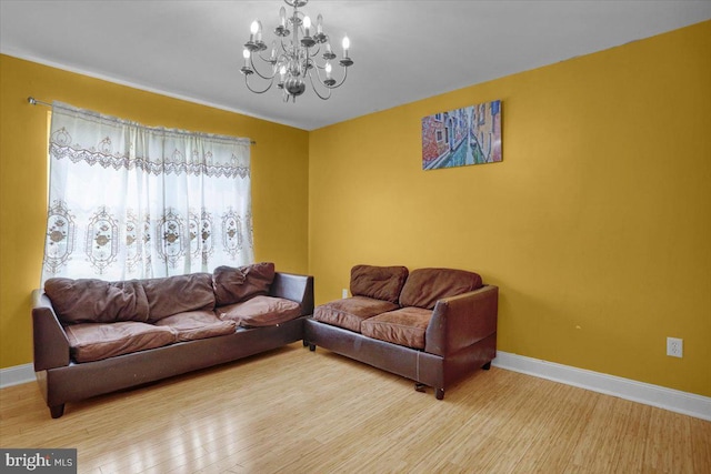 69 Calais Dr, Reading, PA 19605 - living room featuring a chandelier, baseboards, and wood finished floors