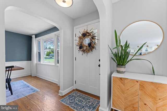 812 E Haverford Rd, Bryn Mawr, PA 19010 - entrance foyer featuring arched walkways, wood finished floors, and baseboards
