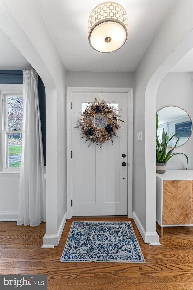 812 E Haverford Rd, Bryn Mawr, PA 19010 - foyer featuring baseboards, wood finished floors, and arched walkways