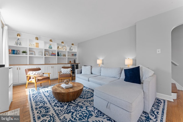 812 E Haverford Rd, Bryn Mawr, PA 19010 - living room featuring arched walkways, light wood-type flooring, and stairway
