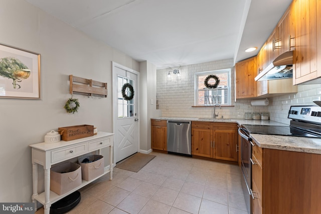 812 E Haverford Rd, Bryn Mawr, PA 19010 - kitchen with stainless steel appliances, under cabinet range hood, a sink, tasteful backsplash, and brown cabinets
