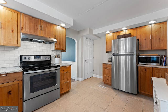 812 E Haverford Rd, Bryn Mawr, PA 19010 - kitchen with under cabinet range hood, appliances with stainless steel finishes, recessed lighting, decorative backsplash, and baseboards