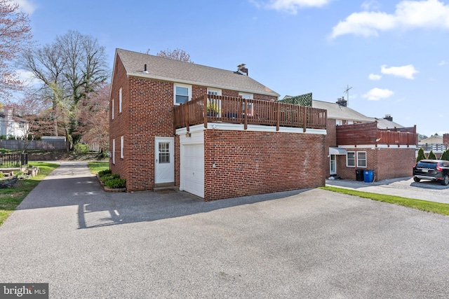 812 E Haverford Rd, Bryn Mawr, PA 19010 - back of house featuring driveway, a garage, and brick siding