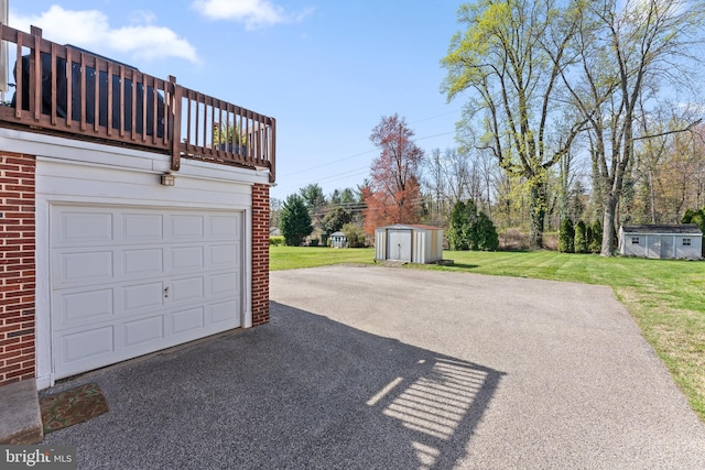 812 E Haverford Rd, Bryn Mawr, PA 19010 - garage featuring asphalt driveway and a storage unit
