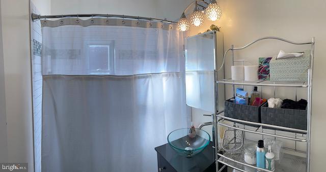 3936 NE Blaine St NE, Washington, DC 20019 - bathroom with vanity and curtained shower